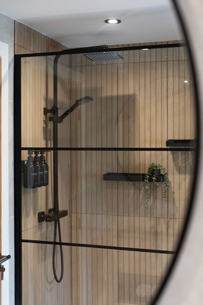Detail shot of a shower area with a round mirror